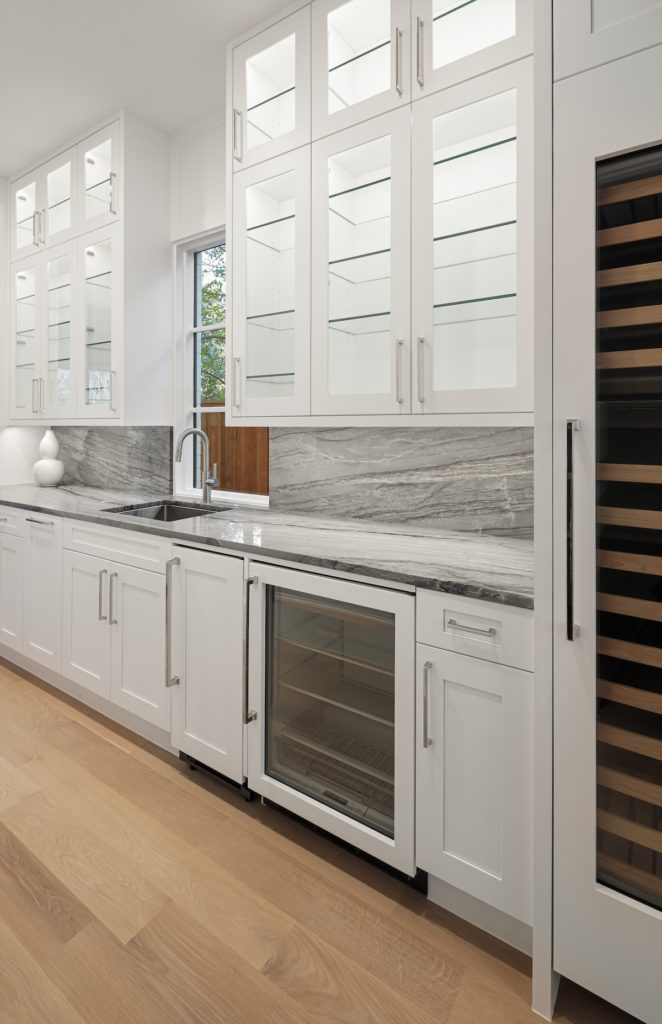 The kitchen includes a built-in coffee bar, two wine coolers, a U-Line ice maker.