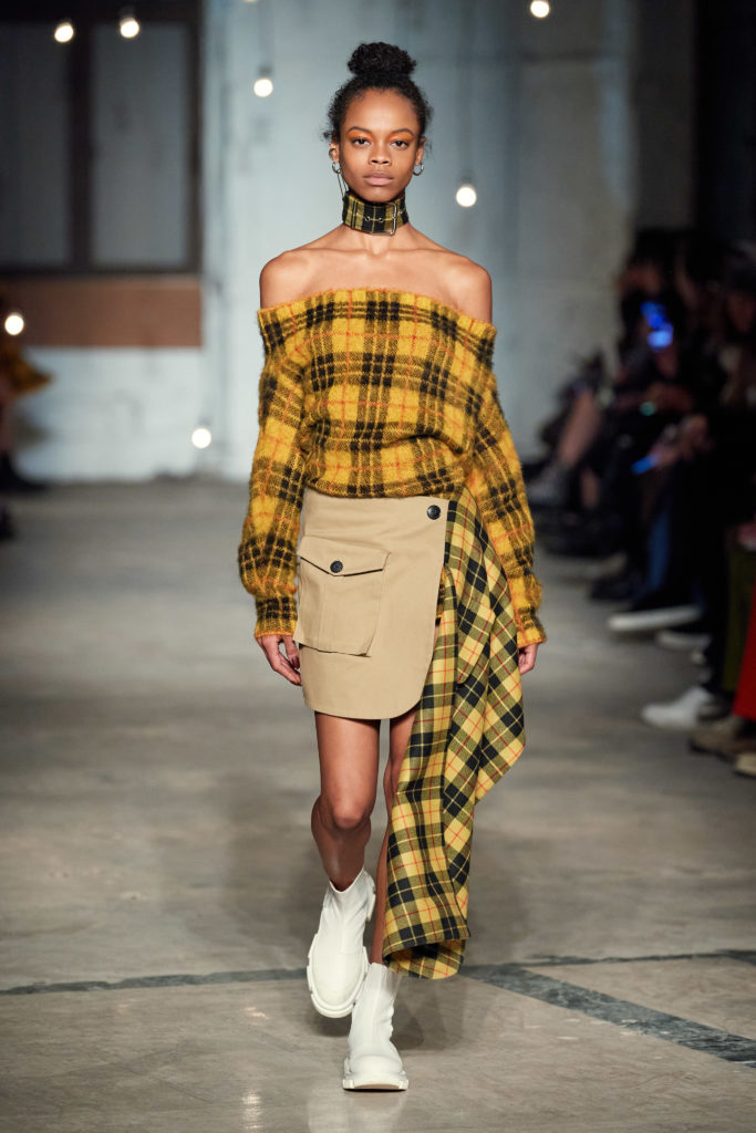 Monse plaid off-the-shoulder mohair sweater dress, plaid pleated cargo skirt. (Photo by Imaxtree)