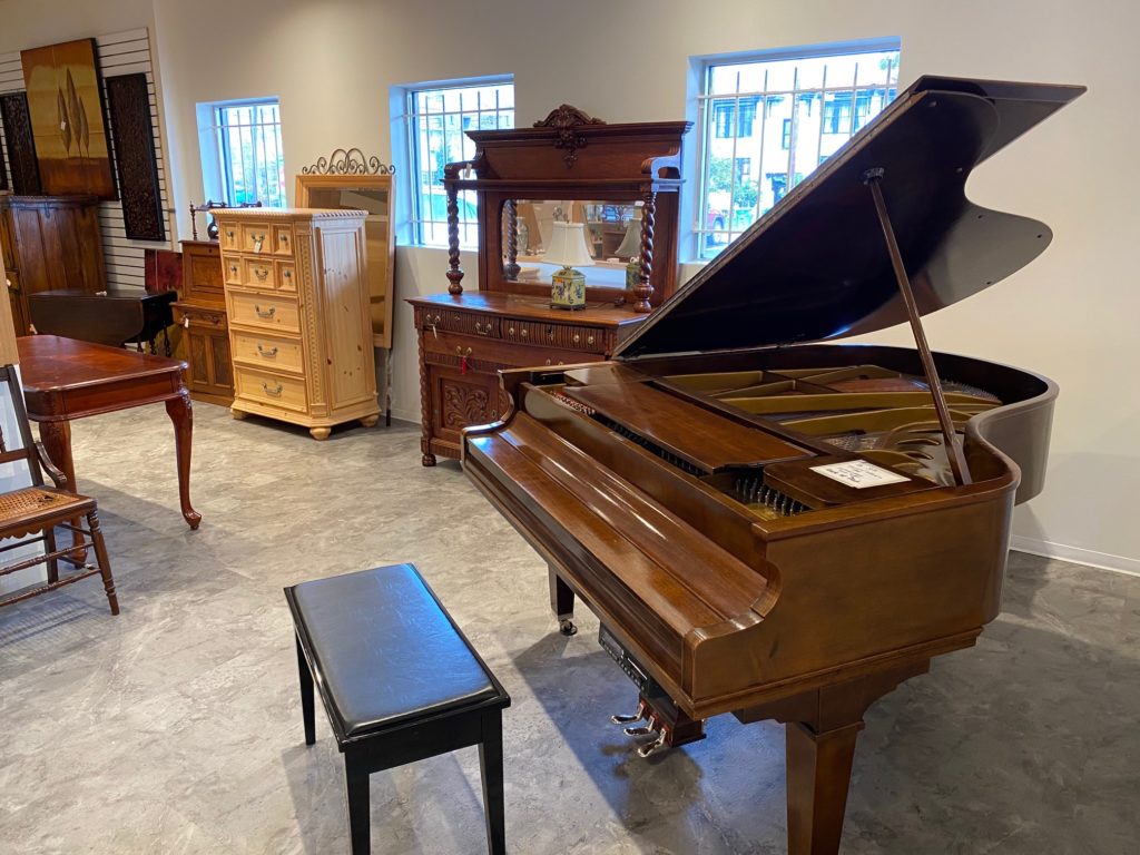 A baby grand piano is among the offerings at the refurbished Blue Bird Circle Resale Shop.  (Photo by Shelby Hodge)