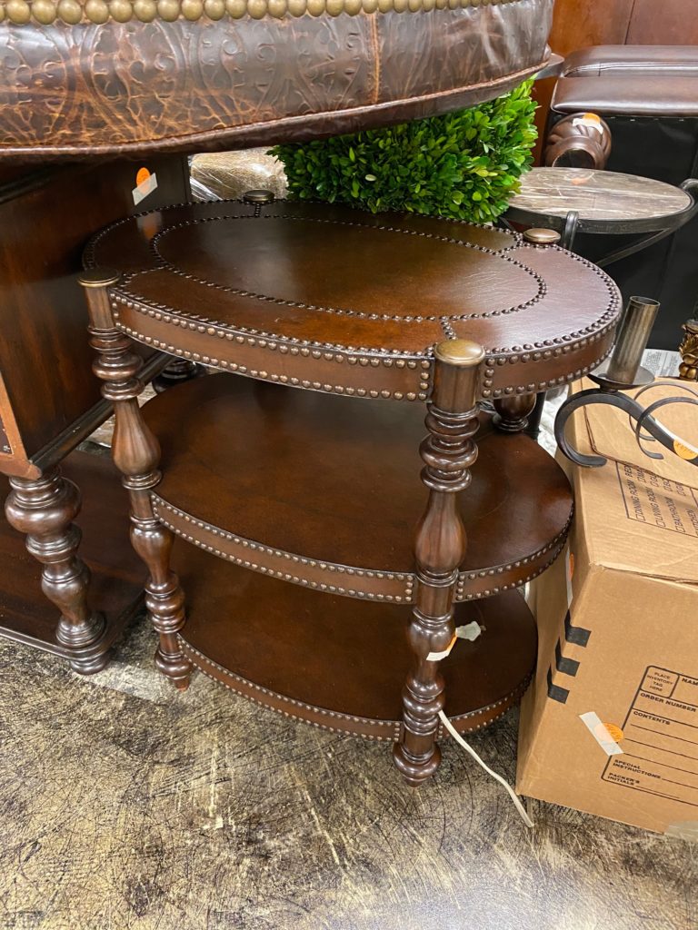 The leather topped and trimmed side table is one of many furniture finds, this one waiting to be displayed on the ground floor. (Photo by Shelby Hodge)