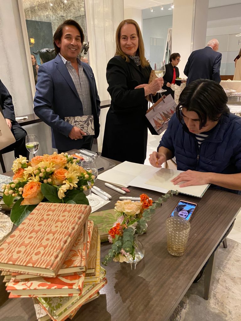 Caricature artist creates portraits in Fortuny gift books at the Donald Sutherland Showroom in the Decorative Center Houston.  (Photo by Shelby Hodge)