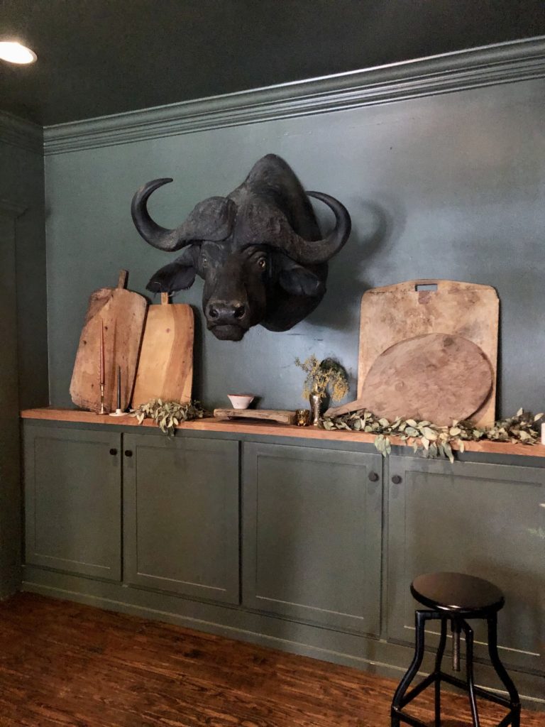 A black buffalo head hovers over a small private event space. (Photo by Megan Ziots)