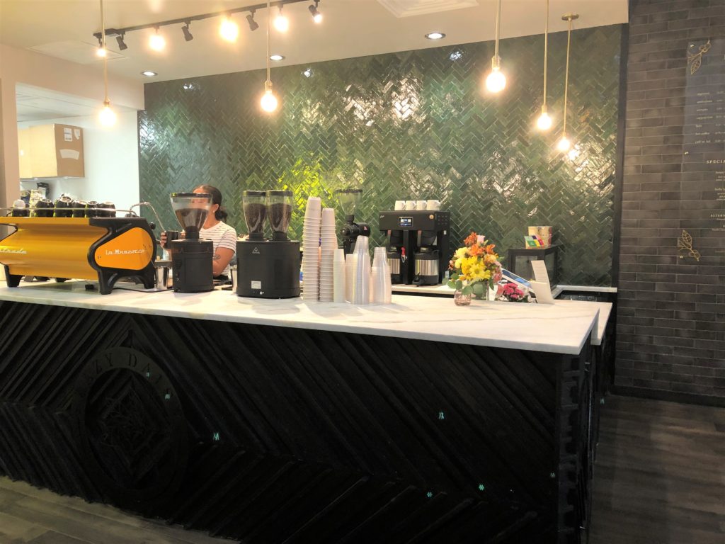 Lazy Daisy's stylish coffee bar backed by green herringbone tiles(photo by Courtney Dabney).