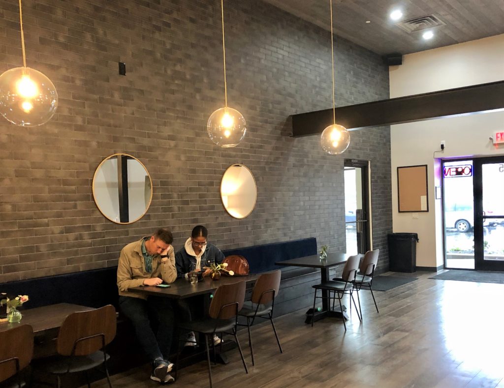 The space includes banquettes, sofas, and even a snug seating nook (photo by Courtney Dabney).