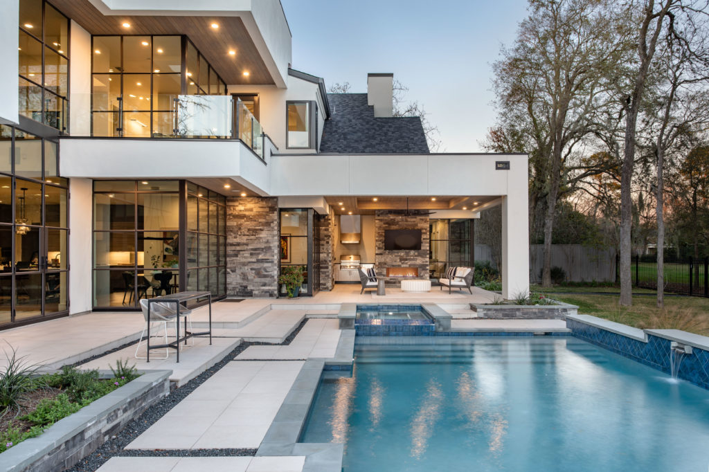 The stepped pool, the summer kitchen and the glass-walled balcony bespeak of Frankel Building Group design touches. (Photo by Kerry Kirk)