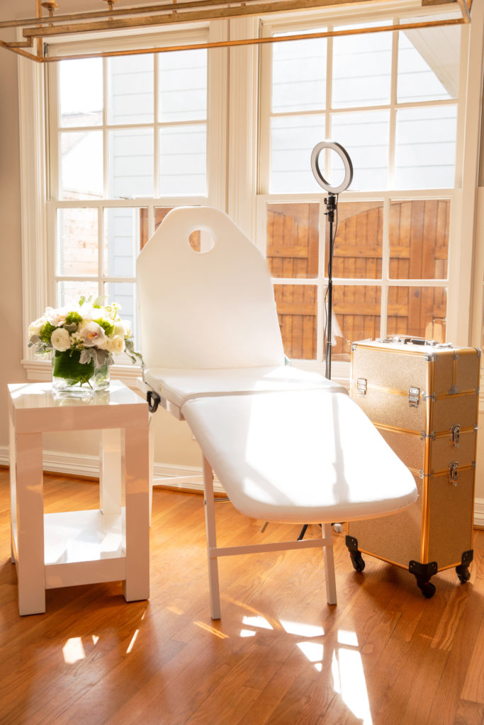 Nurse practitioners provide a gold equipment case, sleek white spa chair, and professional ring light stand.
