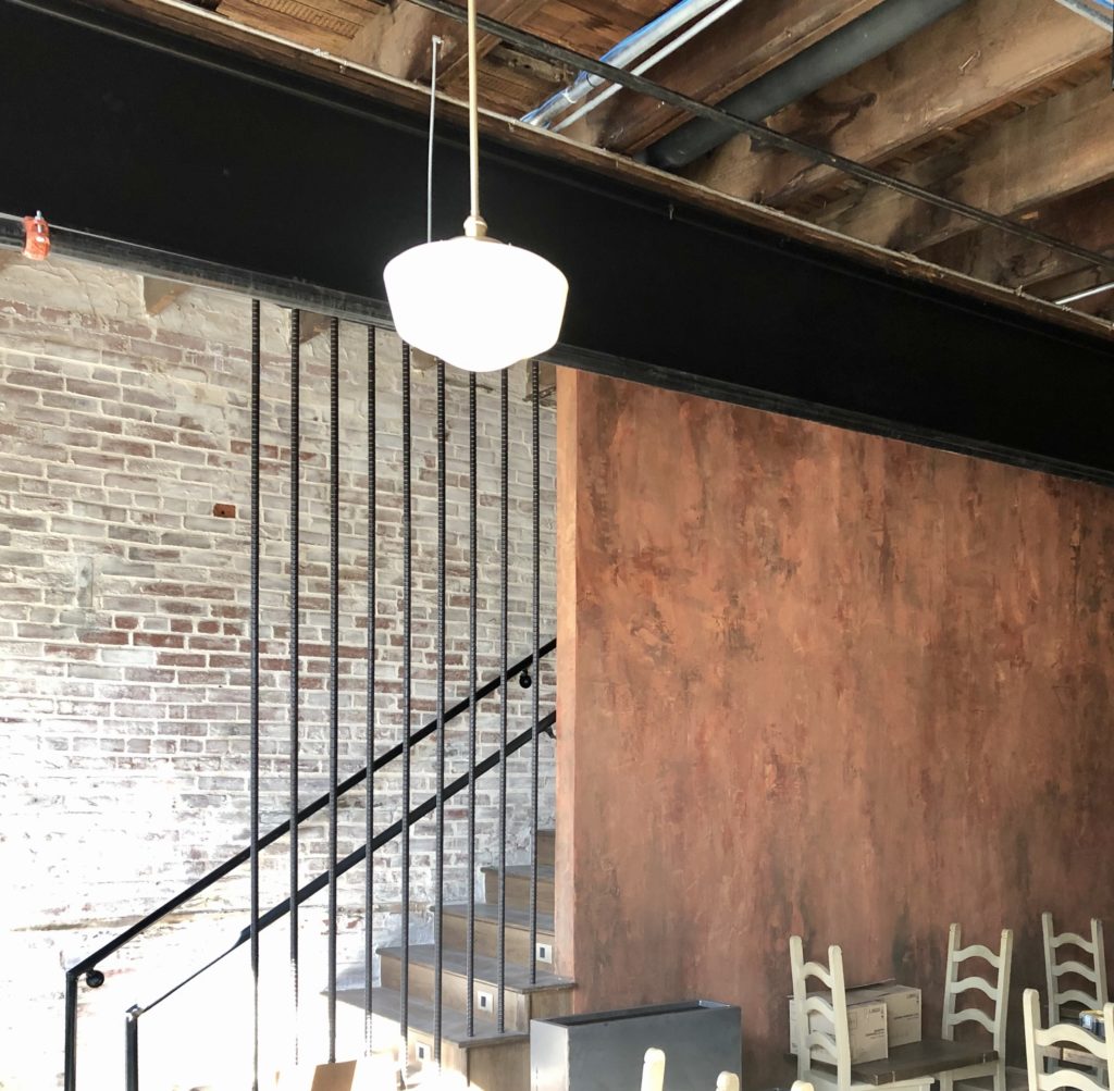 Artistic faux finish near the stairs that lead up to El Escondite Bar. Photo by Courtney Dabney.