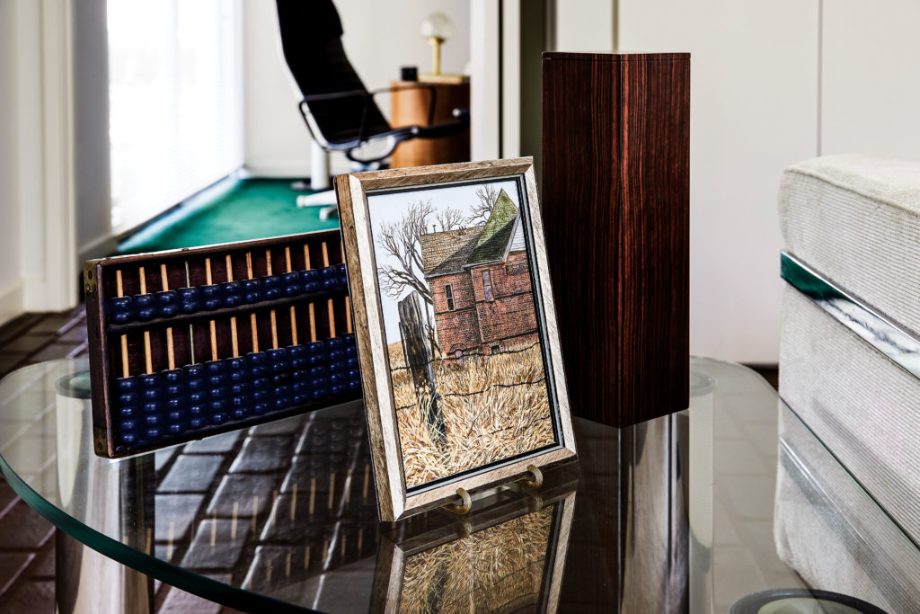 Antique abacus was a gift from Walsh and speaks to a “joint interest in commerce and craft,” says Alan Bruton, UH associate architecture professor, who will author the upcoming book on the designer. Andrew Wyeth-inspired painting of a barn by Anthony Martin, a gift from late architect Ben Brewer. (Photo by Pär Bengtsson)