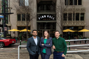 Lionstone Investments’ Hunain Dada, Midway Companies’ Miranda Cartwright,& Culinary Director David Buehrer at Finn Hall; Photo Courtesy of Julie Soefer Photography