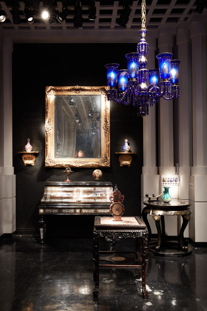 Another rarity, a circa-1900 blue Baccarat chandelier, hangs over a 19th-century Italian desk inlaid with ivory. (Photo by Pär Bengtsson)