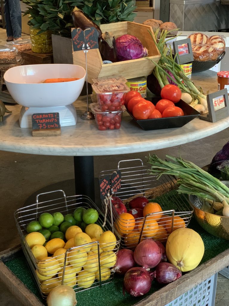 Fresh foods and vegetables are among the essentials on the shelves at Local Foods Rice Village pop up market.  (Photo by Local Foods)
