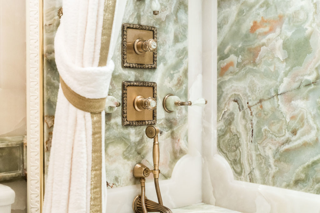 Guest baths are elegantly outfitted in vast expanses of marble. (Photo by Courtesy Douglas Eilliman )