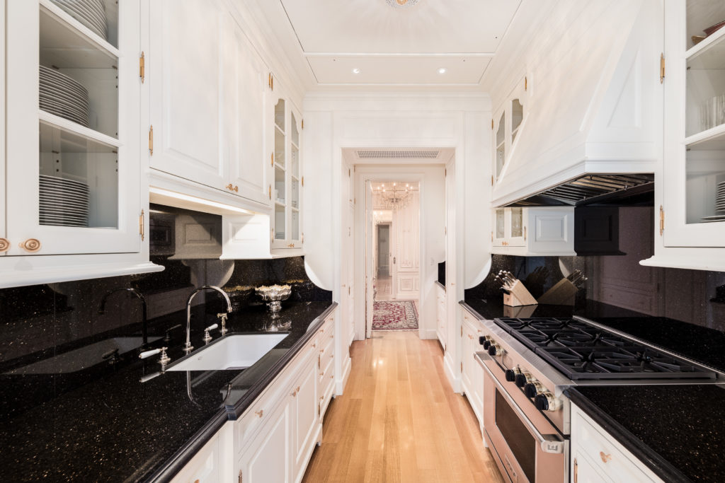 A modern galley style kitchen is located just off of the dining room. (Photo courtesy Douglas Elliman )