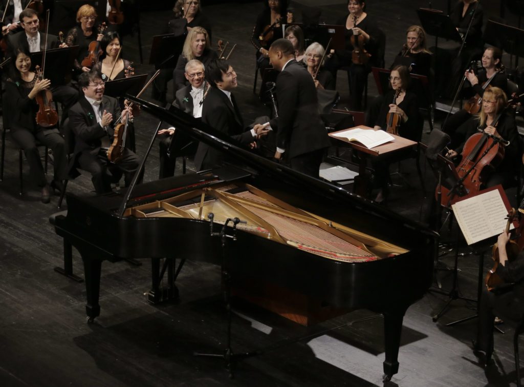 Thomas Yu from Canada performs with the Fort Worth Symphony Orchestra with conductor Damon Gupton in the finals of the Seventh Cliburn International Amateur Piano Competition at Bass Hall in Fort Worth, Tx. (Photo by Ralph Lauer)