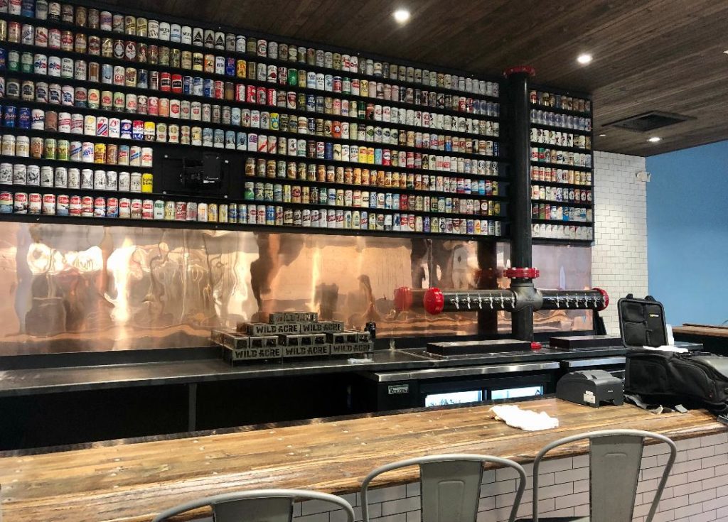 The copper-backed tap wall at the new Camp Bowie location. (Photo by Courtney Dabney).