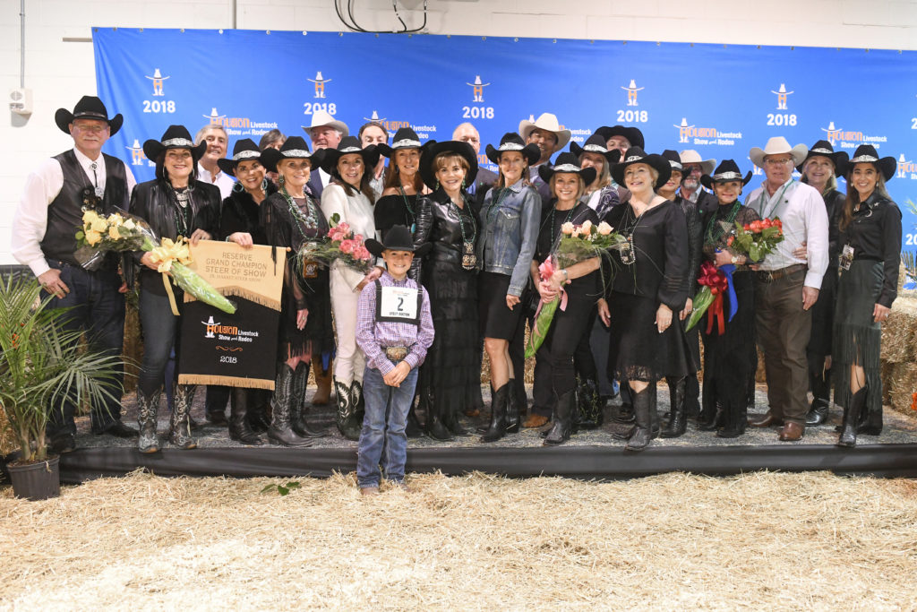 The Champagne Cowgirls and a few of their wranglers with Jett Hale, whose Reserve Grand Champion steer the ladies purchased in 2018.
