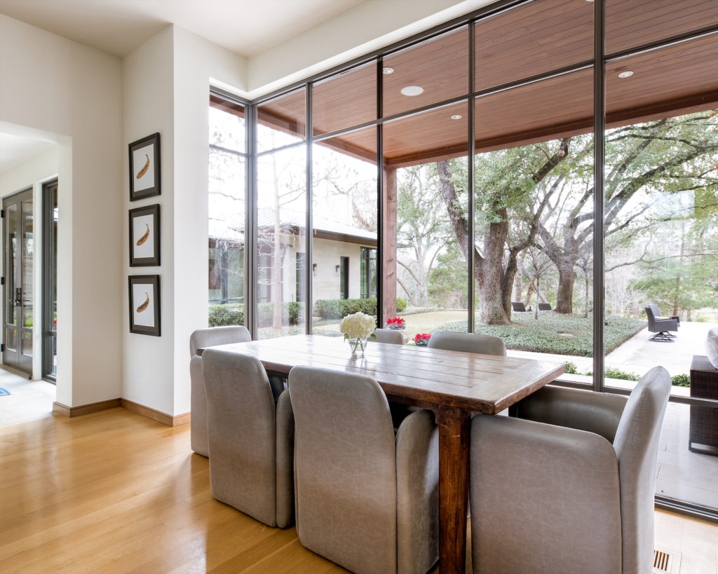 It’s a beautiful, sun-soaked space with dramatic vaulted ceilings, attractive light fixtures, and warm-hued materials that make this new build feel instantly like home.