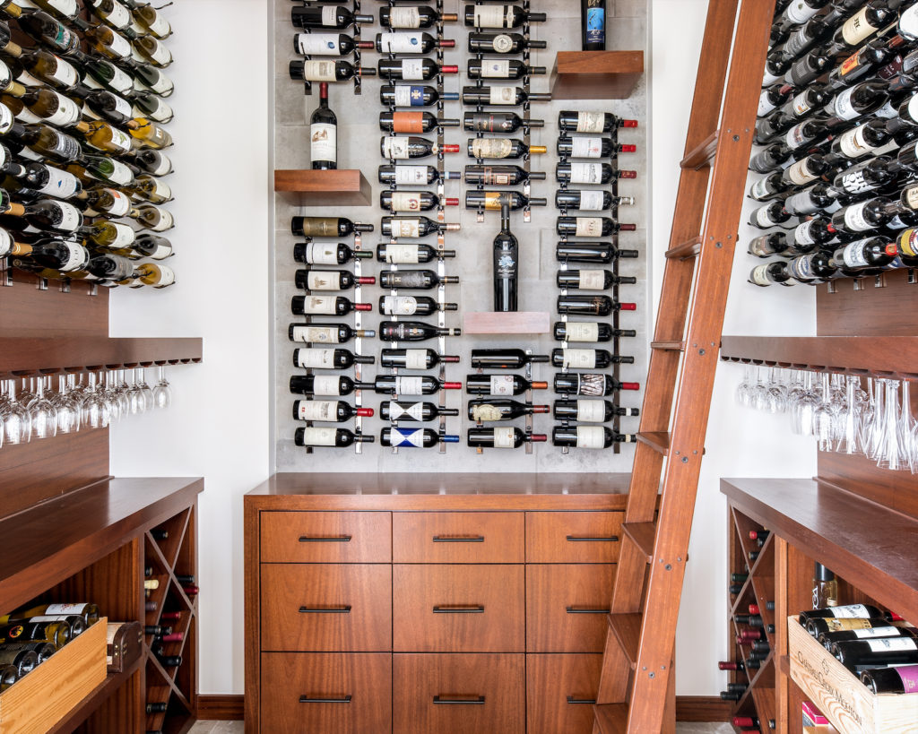A lofty wine room — so towering it requires a built-in ladder.