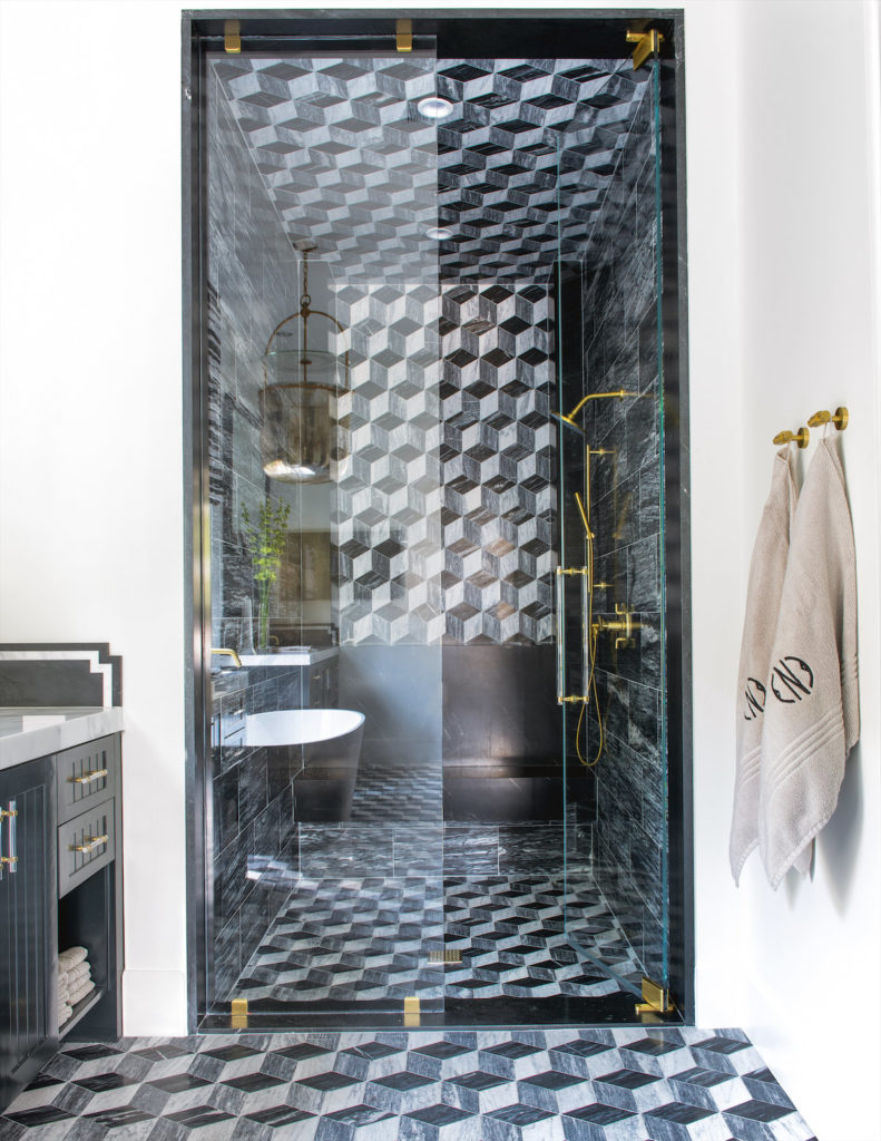 The clients wanted a little edginess in the master bath, so Vanderford covered the walls, floors, and shower in custom black, white, and gray tile from Ann Sacks. (Photo by Costa Christ Media)