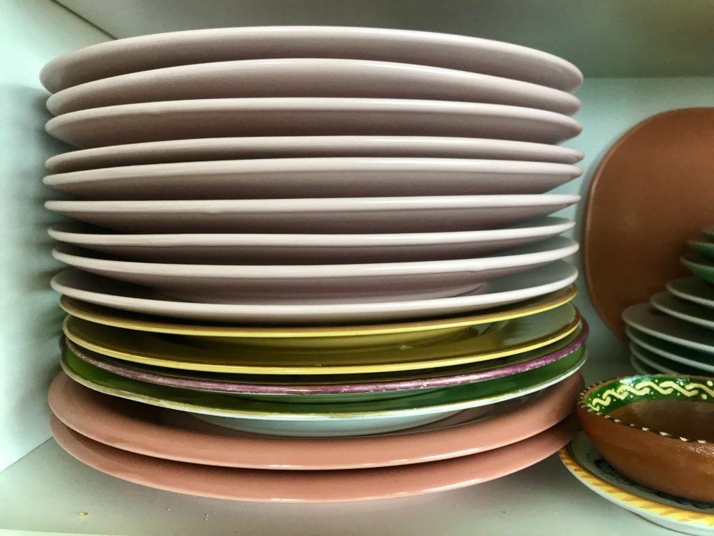 Pink IKEA dinner plates mingle with a collection of other china assembled from places near and far by artist Mary Margaret Hansen.
