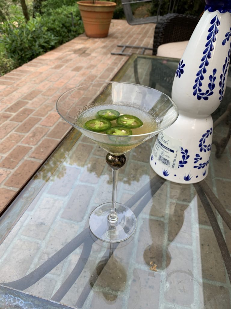 Karen Henry's social distancing cocktail favorite — modified margarita: Fresh lemon, several slices of jalapeño, a teaspoon of honey and Tequila in a shaker poured into a martini glass.