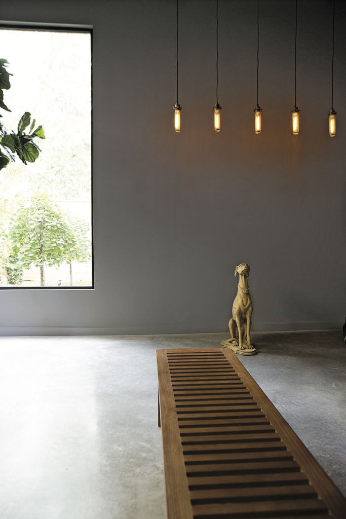 Carol Isaak Barden, published November 2014. Architectural design Scott Strasser. Photographed by Jack Thompson and Jenny Antill Clifton. In the dining room of a house built by Carol Isaak Barden and designed by Scott Strasser are pendant lights designed by George Secaris and greyhound from Carl Moore Antiques.