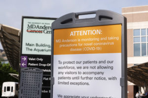 A sign at MD Anderson Cancer Hospital states that visitors will not be allowed to accompany patients in an effort to slow the spread of the COVID-19 coronavirus disease (Photo by F. Carter Smith)