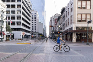 Downtown Houston is eerily quiet, with only essential businesses operating during the coronavirus pandemic. A bicyclist can almost have the run of the city. (Photo by F. Carter Smith)