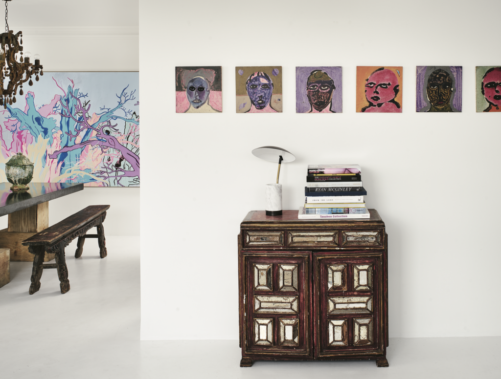 Garrett Hunter, published September 2016. Photographed by Casey Dunn. In designer Garrett Hunter’s high-rise home at The Regency House, an antique mirrored Mexican chest and marble-and-brass lamp. Untitled abstract portraits by Sergio Zenteno, circa 1980, from Dermot Begley, L.A. 