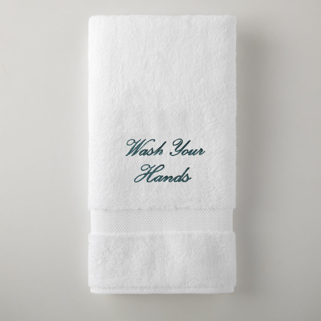 Grange bath towel embroidrerd with "Wash Your Hands" is $25. All proceeds to to funding Peacock Alley's mask-making efforts.
