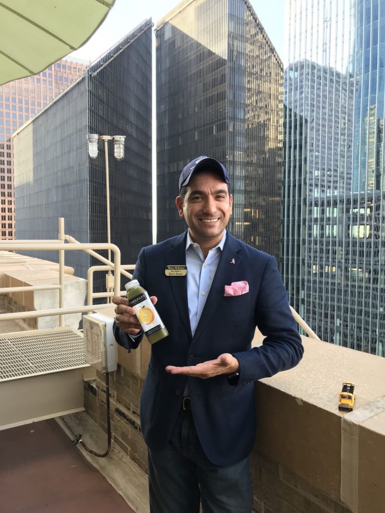 Mister McKinney with his namesake cold-pressed juice on the exclusive VIP 25th floor of the historic 1927 Esperson Building
