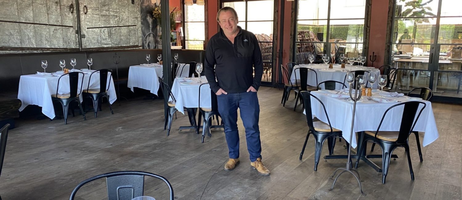 Ben Berg in the upstairs dining room at B&B Butchers where tables have been spread out for 25 percent occupancy. (Photo by Shelby Hodge)