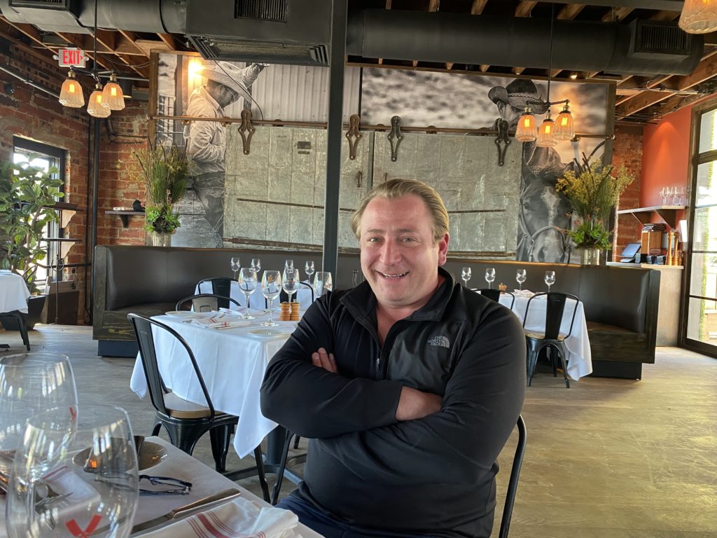 Benjamin Berg in the upstairs dining room at B&B Butchers where tables have been spread out for 25 percent occupancy. (Photo by Shelby Hodge)