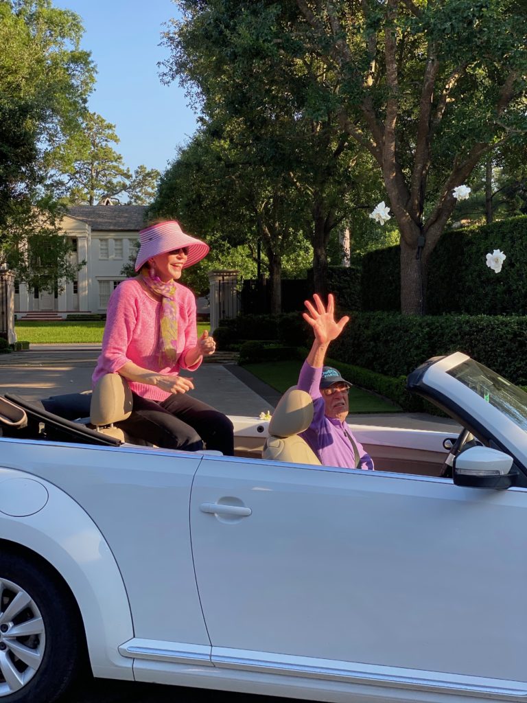 Shelby Hodge and Shafik Rifaat toss dozens of fresh gardenias into the air as a fragrant part of Sheridan Williams' drive-by birthday celebration in April. 