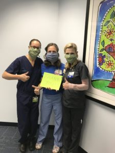 Hospital workers wearing masks made by refugee artisans
