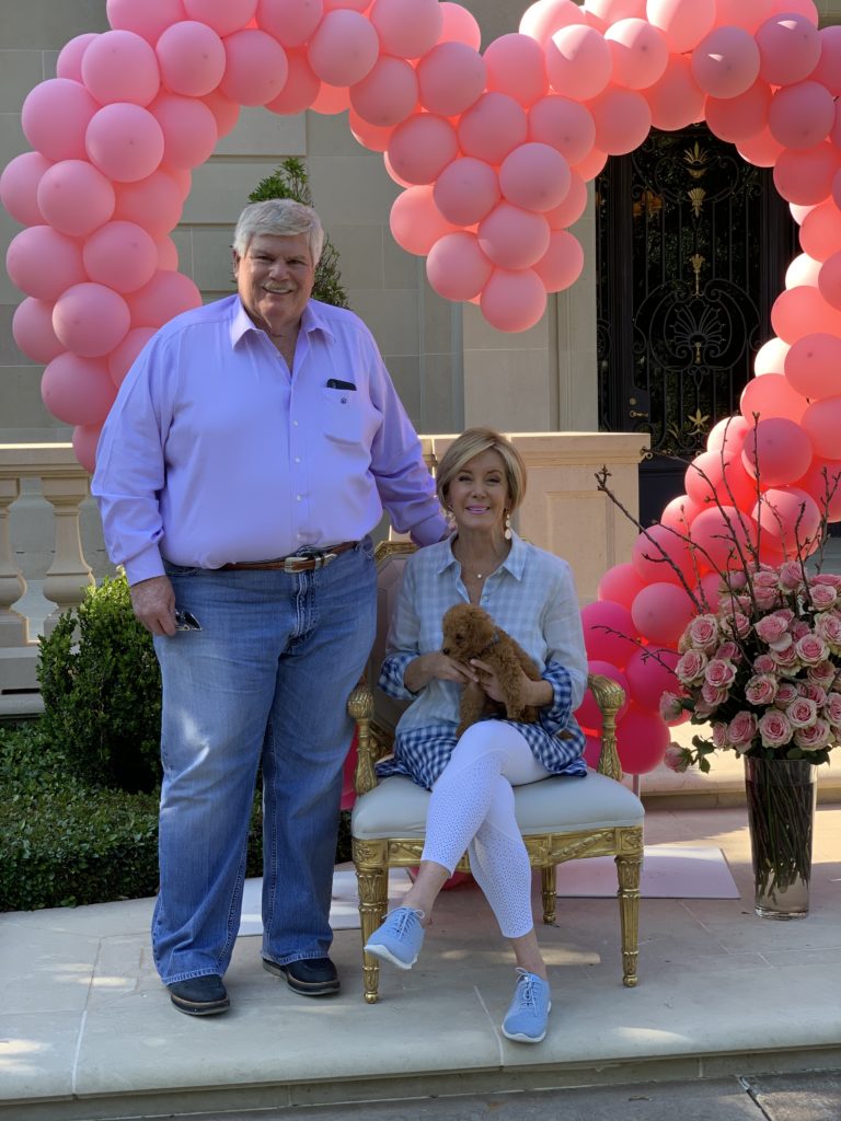 John Eddie & Sheridan Williams in front of the birthday balloons.
