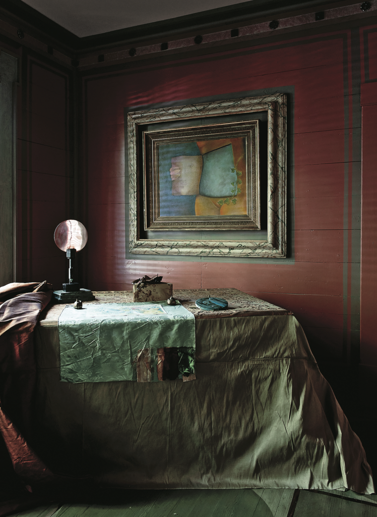 Salle Werner-Vaughn, published September 2012. Photographed by Jenny Antill and Jack Thompson. Artist Salle Werner-Vaughn’s magical 100-year-old cottage, called The Palace by the Way, is one of a cluster of five bungalows titled Harmonium, which Werner-Vaughn has tended to for more than 25 years. A lavish bolt of silk acquired from friend Carol Isaak Barden and a square of sample damask left to her by a favorite upholsterer. Mirror sculpture is by Werner-Vaughn, as is the painting, "Within," 1967.