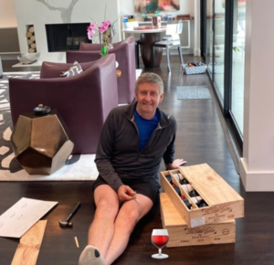 Businessman Tom Glanville works on his wine collection while social isolating.