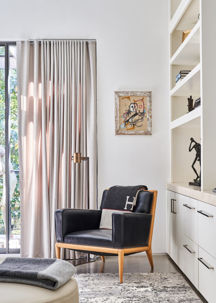 The TV area on the second floor includes a T.H. Robsjohn-Gibbings chair from Sputnik Modern. Holly Hunt floor lamp.
Brian Nadurak painting. (Photo by Stephen Karlisch)