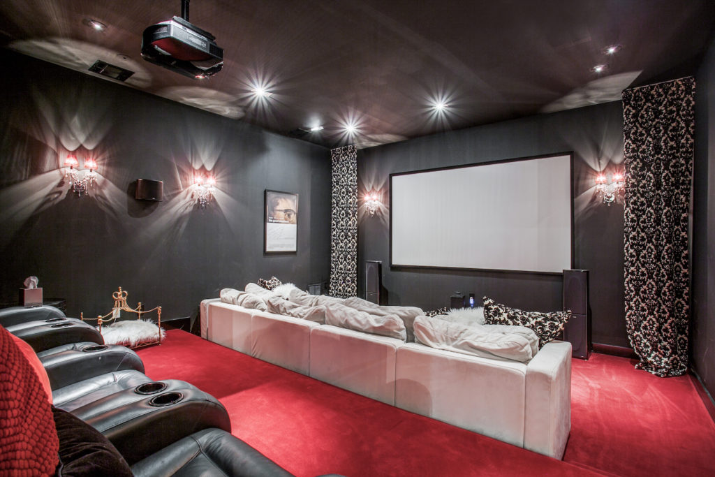 A home movie theater — elaborate dog bed likely not included. (Photo by Compass Real Estate)