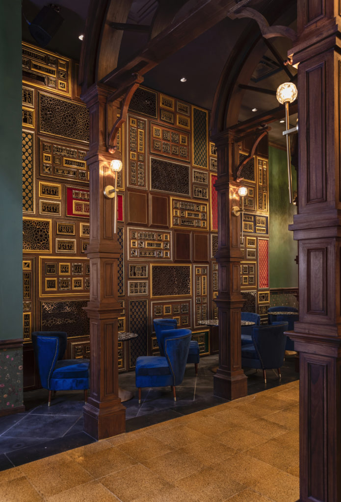 In The Traveler's Room, a 25-foot-long Dhokra wall featuring brass castings of folk motifs is framed by 16-foot carved wooden colonnades. (Photo by Julie Soefer)