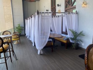 The outdoor lounge at Musaafer is complimented by daybeds draped colonial style in linen and featuring plump bolsters. (Photo by Michael Anthony)