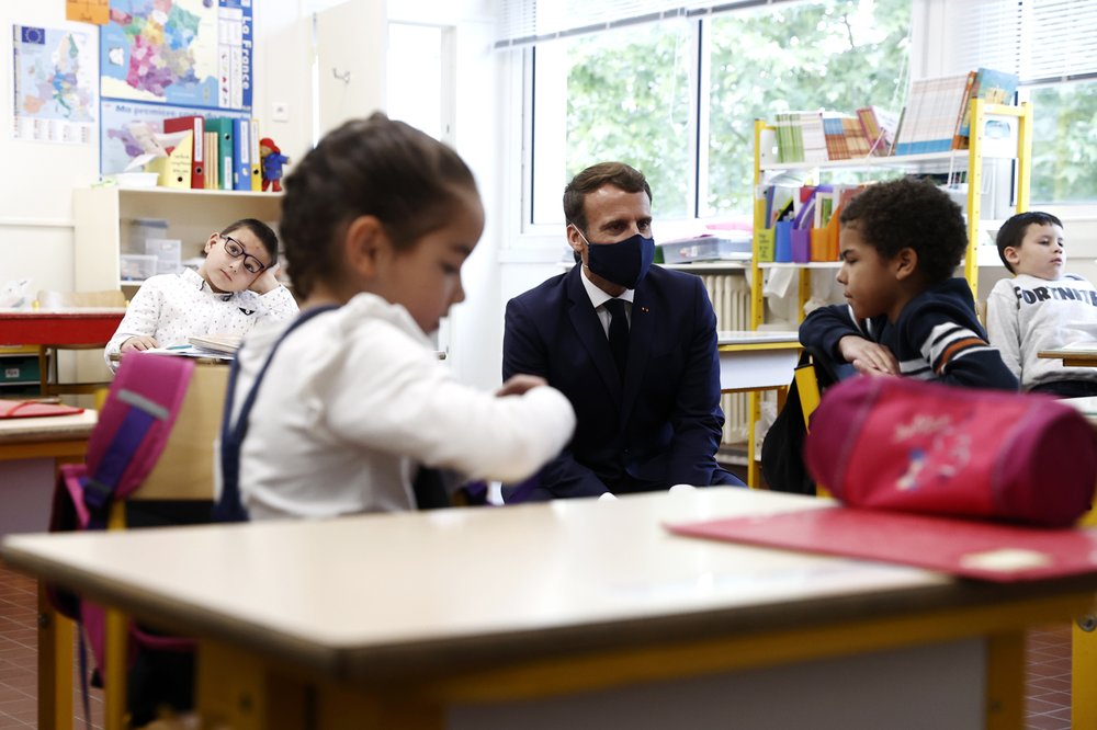 French president Emmanuel Macron debuts new face mask on visit to primary school.  (Photo by Ian Langsdon, pool photographer.)
