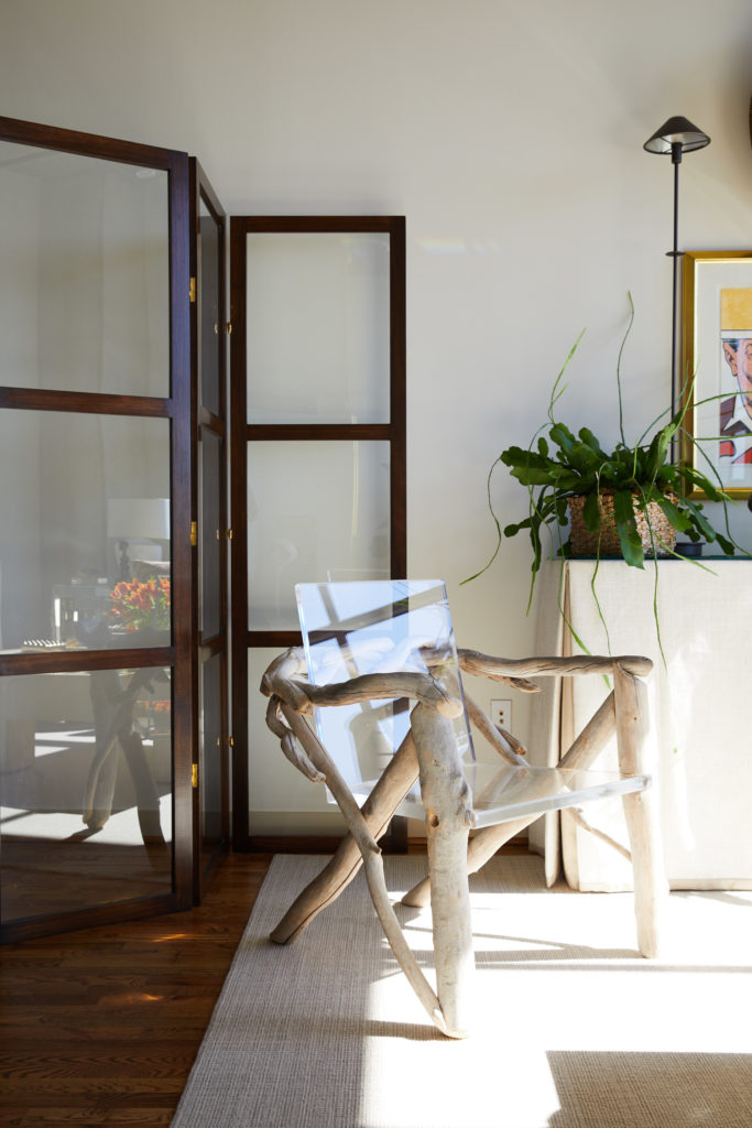 The vintage driftwood-and-acrylic chair was found on a trip to New Mexico. Mahogany-and-glass screen designed by Christopher Alexander. Both offer translucency to keep the space feeling open and airy.  (Photo by Pär Bengtsson)
