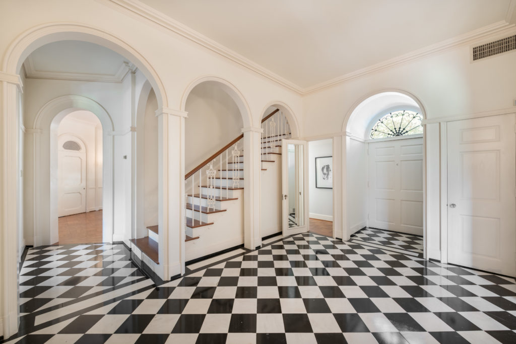 The black and white marble entry creates a powerful welcome to guests in the John Staub house. (Photo by Vlady Ambia)