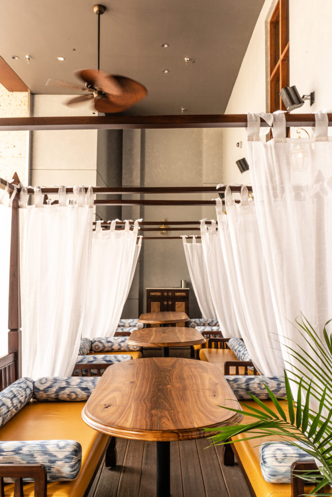 The outdoor lounge at Musaafer is complimented by daybeds draped colonial style in linen and featuring plump bolsters. (Photo by Michael Anthony)