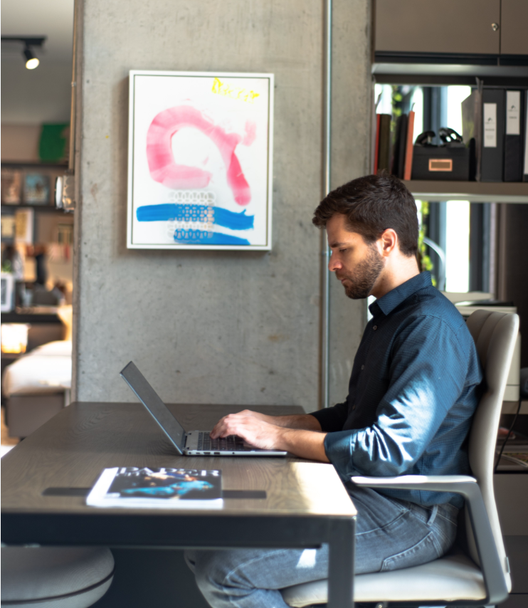 CAM Studio's Roger Leal Martinier at his desk with a work by L.A. painter Martin Durazo, "LOV-R," 2015, represented and curated by Barbara Davis Gallery. (Photo by Krzysztof Kwiatkowski)  