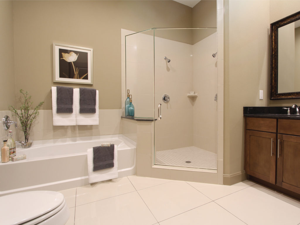 Tuscany Walk bathrooms feature frameless glass walk-in showers with separate soaking tubs.