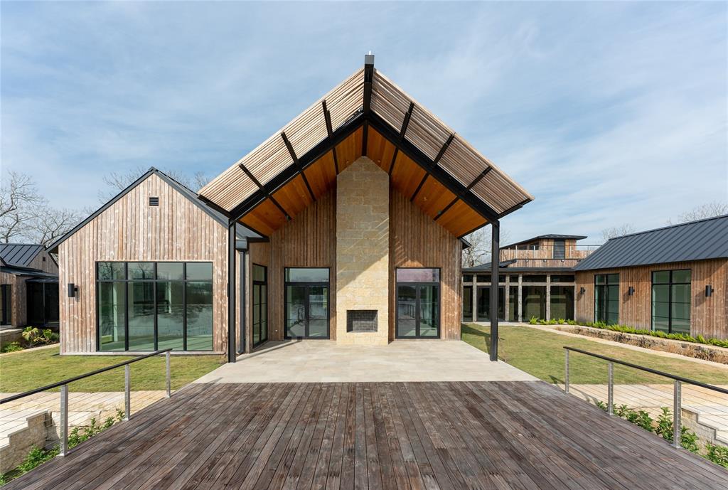 The back patio at 35711 Vernon Frost Road opens to a cantilevered deck the overlooks Lake Lucille. (Photo by ProHouse)