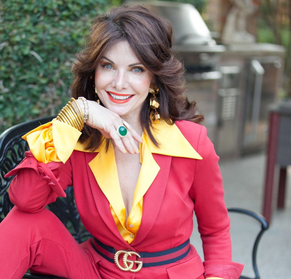 Marla Hurley, always dressed to impress, creates a pose for her consignment website. Before the pandemic, her calendar was filled with charitable activities.
